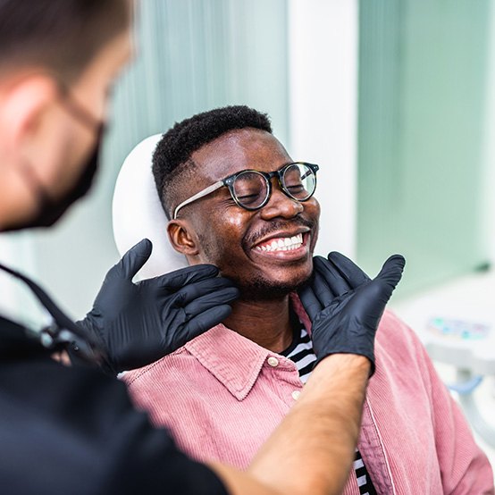 Older woman receiving a dental checkup and cleaning in Jupiter