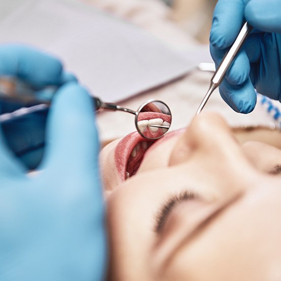 A patient having their teeth checked