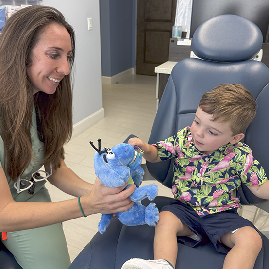 Young boy smiling during dental checkup with childrens dentist in Jupiter