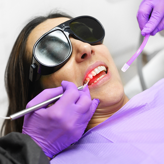 Woman receiving treatment with laser dental technology in Jupiter