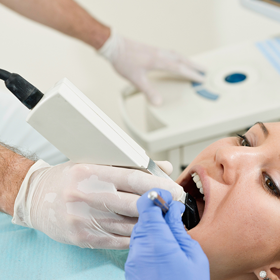 Dental patient having digital impressions taken of her teeth