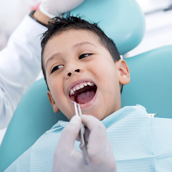 Young boy smiling during dental checkup with childrens dentist in Jupiter