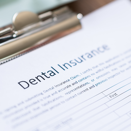 Dental insurance form on clipboard