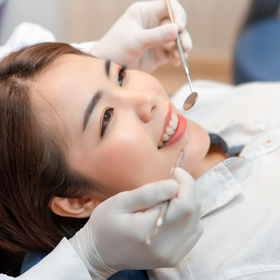 Young woman smiling during a preventive dentistry checkup in Jupiter