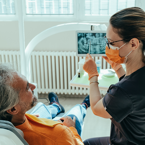 Dentist showing a patient an x ray of their teeth