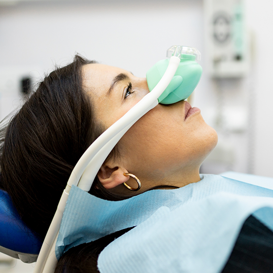 Dental patient with mask over her nose for nitrous oxide sedation dentistry in Jupiter